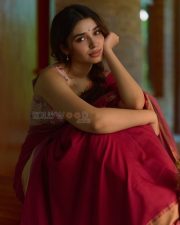 Beautiful Telugu Actress Krithi Shetty in a Maroon Red Silk Saree with a Cream Sleeveless Blouse Pictures 07