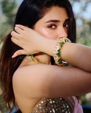 Breathtaking Actress Krithi Shetty in a Gold Mirror Work Lehenga Photos 09