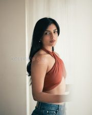 Charming Actress Ashna Zaveri in a Rust Crossover Halter Crop Top and Denim Jeans Photos 04