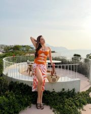 Dazzling Actress Zaara Yesmin in a Orange Cut Out Swimsuit And Tropical Print Sarong Photos 07