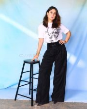 Elegant Bollywood Actress Kareena Kapoor Khan in a White Abstract Printed T Shirt with Black Striped Pants Photos 02