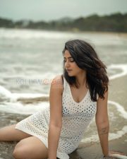 Enchanting Actress Varshini Sounderajan in a White Crochet Mini Dress Photos 03