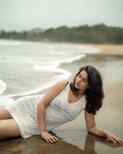 Enchanting Actress Varshini Sounderajan in a White Crochet Mini Dress Photos 05