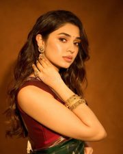 Manamey Heroine Krithi Shetty in a Green Traditional Kanchipuram Silk Saree with a Contrasting Maroon Sleeveless Blouse Pictures 01