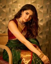 Manamey Heroine Krithi Shetty in a Green Traditional Kanchipuram Silk Saree with a Contrasting Maroon Sleeveless Blouse Pictures 04