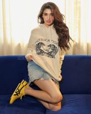 Sexy and Hot Krithi Shetty in a Cream Hoodie with a Blue Denim Mini Shorts Photos 05