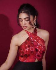 Telugu Actress Krithi Shetty in a Red Cutout Halter Neck Top and Black Skirt Pictures 01