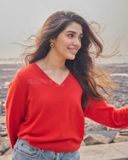 Vaa Vaathiyaar Heroine Krithi Shetty in a Red V Neck Knit Sweater and a High Waisted Light Blue Denim Shorts Photos 02