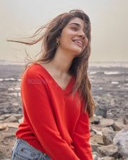 Vaa Vaathiyaar Heroine Krithi Shetty in a Red V Neck Knit Sweater and a High Waisted Light Blue Denim Shorts Photos 03