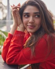 Vaa Vaathiyaar Heroine Krithi Shetty in a Red V Neck Knit Sweater and a High Waisted Light Blue Denim Shorts Photos 04
