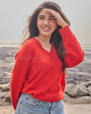 Vaa Vaathiyaar Heroine Krithi Shetty in a Red V Neck Knit Sweater and a High Waisted Light Blue Denim Shorts Photos 07