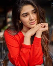 Vaa Vaathiyaar Heroine Krithi Shetty in a Red V Neck Knit Sweater and a High Waisted Light Blue Denim Shorts Photos 08