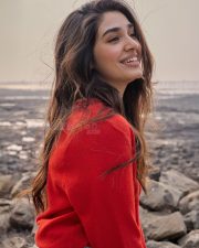 Vaa Vaathiyaar Heroine Krithi Shetty in a Red V Neck Knit Sweater and a High Waisted Light Blue Denim Shorts Photos 09