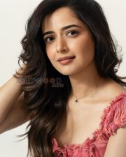 Charming Actress Ashika Ranganath in a Pink Ruffled Crop Top and Light Blue Wide Leg Jeans Photos 01