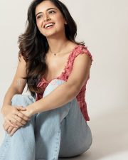 Charming Actress Ashika Ranganath in a Pink Ruffled Crop Top and Light Blue Wide Leg Jeans Photos 02