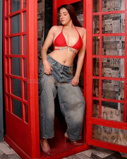 Provocative Archana Singh Rajput Cleavage in a Red Bikini Top Low rise Denim Jeans Photos 07