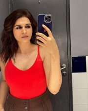 Sexy Telugu Beauty Shraddha Das Selfie in a Red Sleeveless Top and Brown High Waisted Pants Photos 02