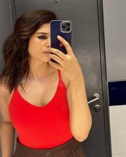 Sexy Telugu Beauty Shraddha Das Selfie in a Red Sleeveless Top and Brown High Waisted Pants Photos 03