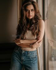 Stunning Ashika Ranganath in a White Crop Top and Ripped Blue Jeans Photos 01
