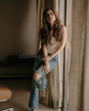 Stunning Ashika Ranganath in a White Crop Top and Ripped Blue Jeans Photos 03