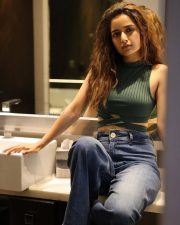 Stylish Beauty Ashika Rangnath in a Green Sleeveless Ribbed Crop Top and Blue Denim Photos 01