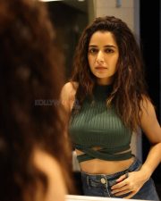 Stylish Beauty Ashika Rangnath in a Green Sleeveless Ribbed Crop Top and Blue Denim Photos 02