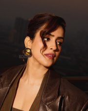 Toaster Actress Sanya Malhotra in a Long Structured Brown Leather Trench Coat with a Tailored Pinstripe Corset Style Vest with a Wide Leg Pinstripe Pants Photos 04