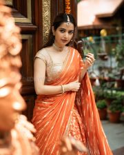 Traditional Beauty Ashika Ranganath in an Orange Lehenga Photos 05