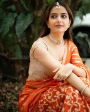 Traditional Beauty Ashika Ranganath in an Orange Lehenga Photos 07