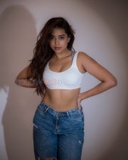 Athletic Actress Rittika Chakraborty in a White Racerback Crop Top with Blue Distressed Jeans Photos 02