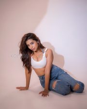 Athletic Actress Rittika Chakraborty in a White Racerback Crop Top with Blue Distressed Jeans Photos 09