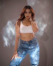 Athletic Actress Rittika Chakraborty in a White Racerback Crop Top with Blue Distressed Jeans Photos 10