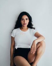 Charming Beauty Ruhani Sharma in a White Knotted T Shirt with a High Waisted Black Mini Shorts Photos 02