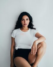 Charming Beauty Ruhani Sharma in a White Knotted T Shirt with a High Waisted Black Mini Shorts Photos 02