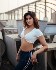 Desirable Sakshi Malik in a White Short Sleeved Crop Top with a Navy Blue Track Pants Photos 01