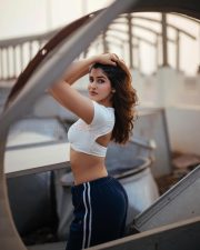 Desirable Sakshi Malik in a White Short Sleeved Crop Top with a Navy Blue Track Pants Photos 02