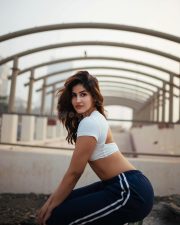 Desirable Sakshi Malik in a White Short Sleeved Crop Top with a Navy Blue Track Pants Photos 03