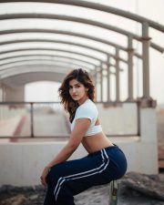 Desirable Sakshi Malik in a White Short Sleeved Crop Top with a Navy Blue Track Pants Photos 04