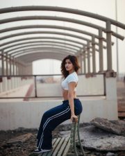 Desirable Sakshi Malik in a White Short Sleeved Crop Top with a Navy Blue Track Pants Photos 05