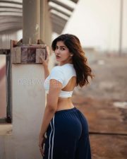 Fierce Sakshi Malik Midriff in a White Crossover Crop Top and Navy Track Pants Photos 02