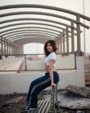 Fierce Sakshi Malik Midriff in a White Crossover Crop Top and Navy Track Pants Photos 04
