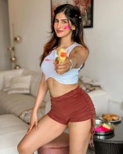 Sexy Hot Babe Sakshi Malik in a White Crop Top and Brown Mini Shorts for Holi Photos 02
