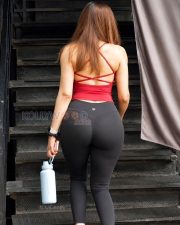 Vibrant Actress Sakshi Malik in a Red Halter Racerback Athletic Tank Top and Black Yoga Leggings Photos 02