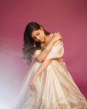 Elegant Actress Kalyani Priyadarshan in a champagne embellished saree with ornate gold earrings photos 04