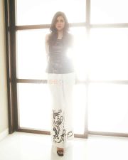 Elegant Chic Beauty Kalyani Priyadarshan in a Black Leather Top with White Pants Photos 06