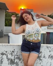 Glowing Actress Poonam Bajwa in a White Crochet Crop Top and Denim Shorts Photos 01