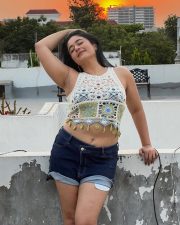 Glowing Actress Poonam Bajwa in a White Crochet Crop Top and Denim Shorts Photos 02