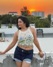 Glowing Actress Poonam Bajwa in a White Crochet Crop Top and Denim Shorts Photos 03