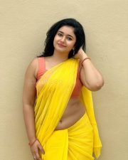 Mesmerizing Poonam Bajwa in a Yellow Saree with Sleeveless Orange Blouse Photos 08