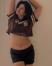 Stylish Actress Poonam Bajwa in a Brown varsity crop jersey Photos 03
